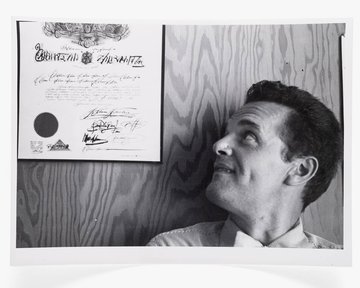 Photograph of Charles Eames with Steinberg Diploma