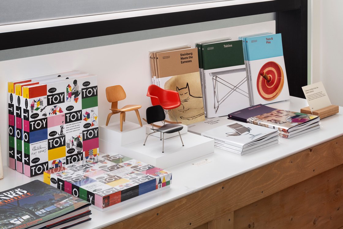 Eames Institute exhibition catalogs sit beside several books on display at the shop in Richmond California.