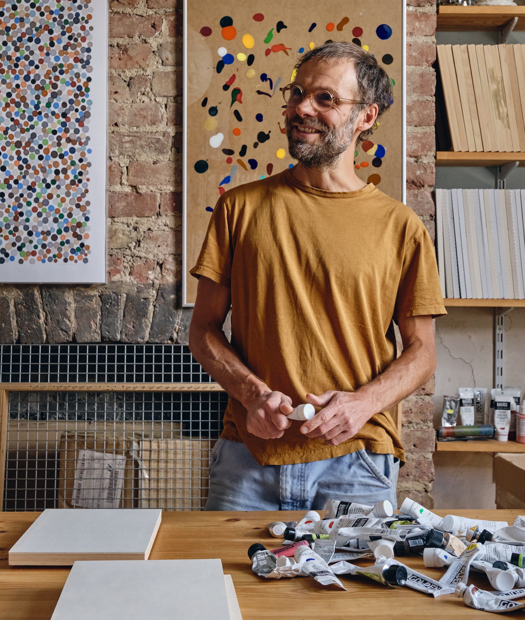 Artist Daniel Eatock in his London art studio among one of his felt-tip prints and a clip frame painting.