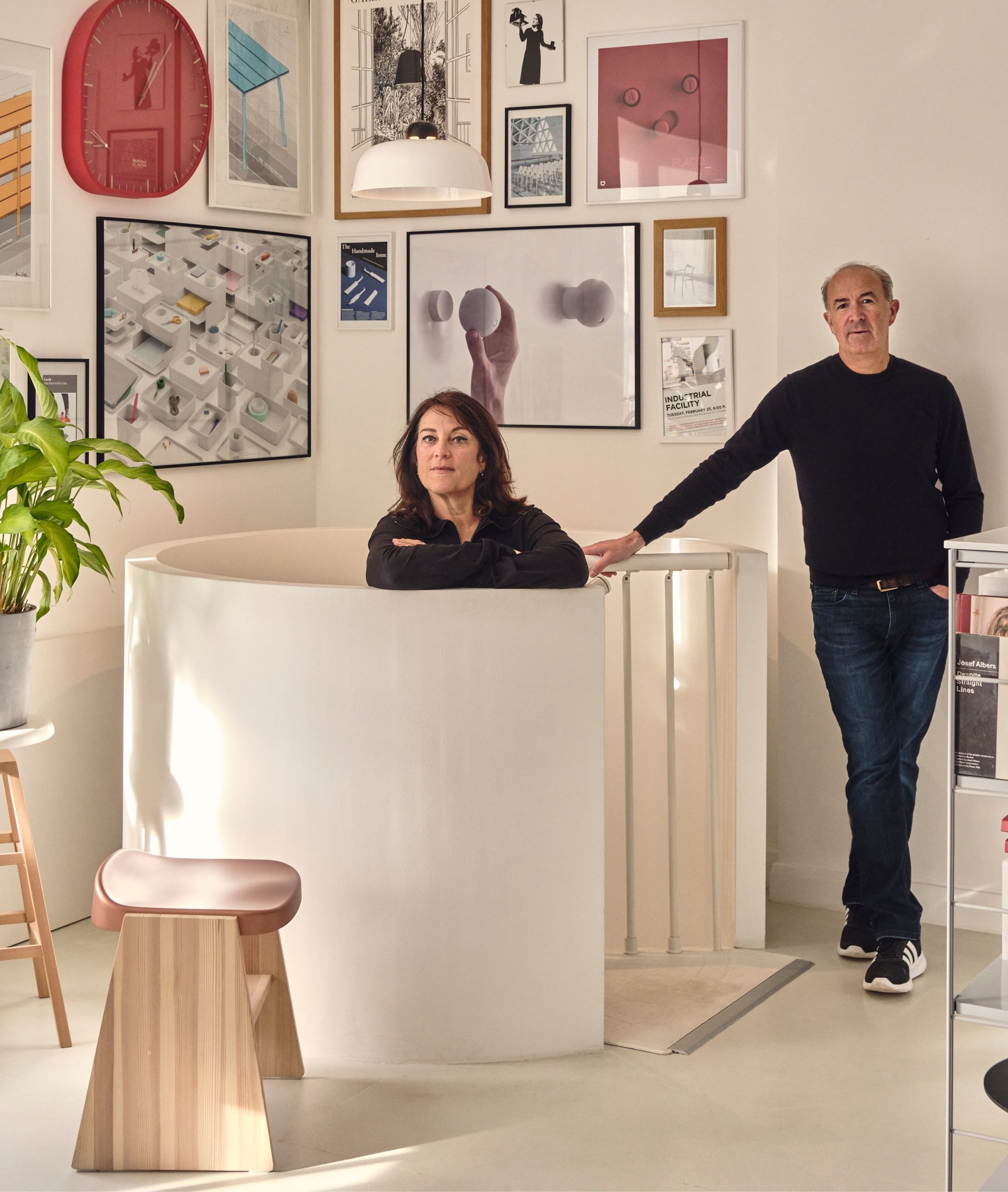 Designers Sam Hecht and Kim Colin of Industrial Facility in their London design studio surrounded by posters of their work.
