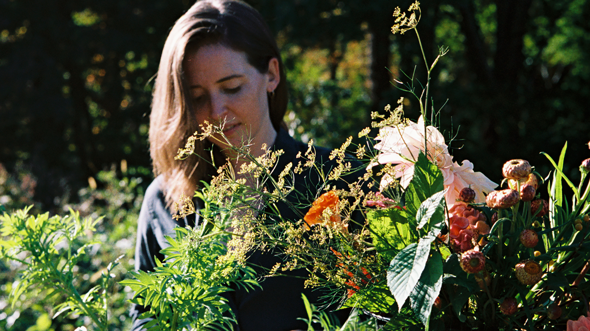 MASS Design Group's Caitlin Taylor tending to flowers at Four Root Farm in East Haddam, Connecticut.