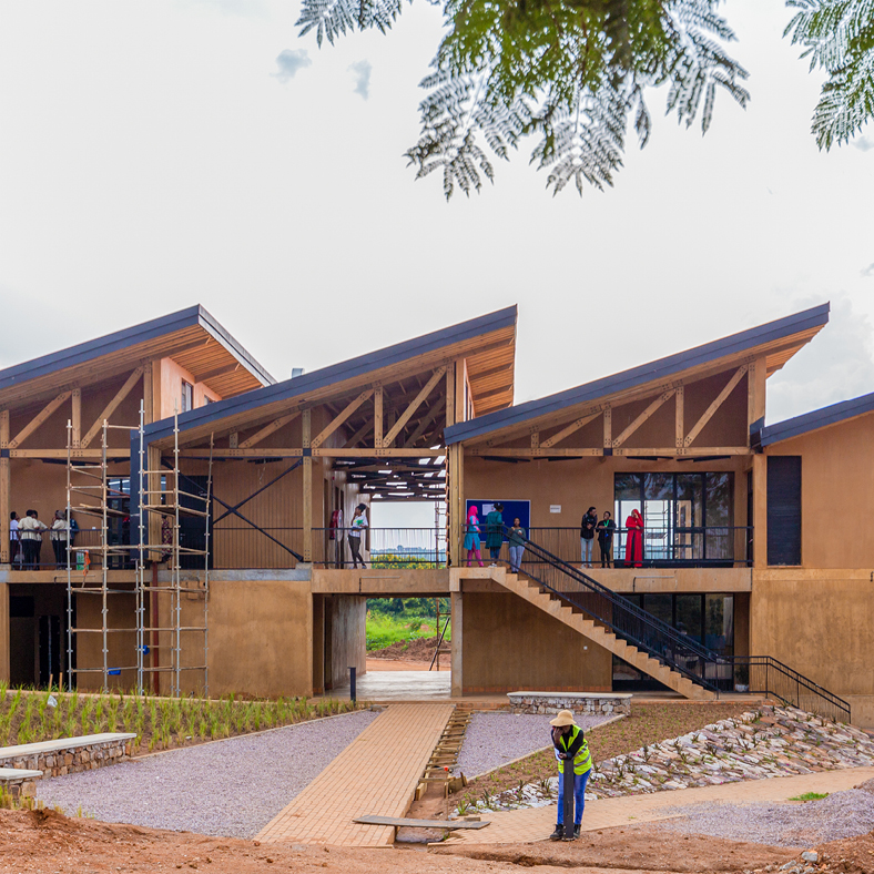 Exterior of Rwanda Institute for Conservation Agriculture building made of wood with angled passive solar roofs.
