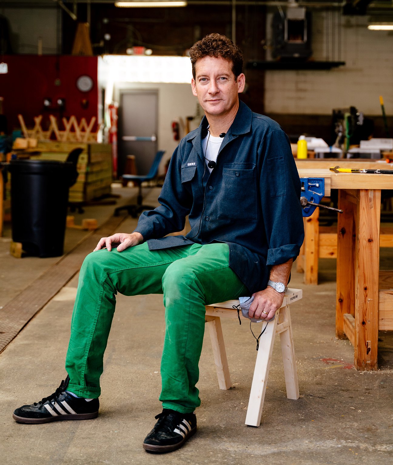 Nick Tobier, co-founder of the Brightmoor Maker Space sitting on a handmade Ishinomaki wooden stool, Kazam! Magazine.