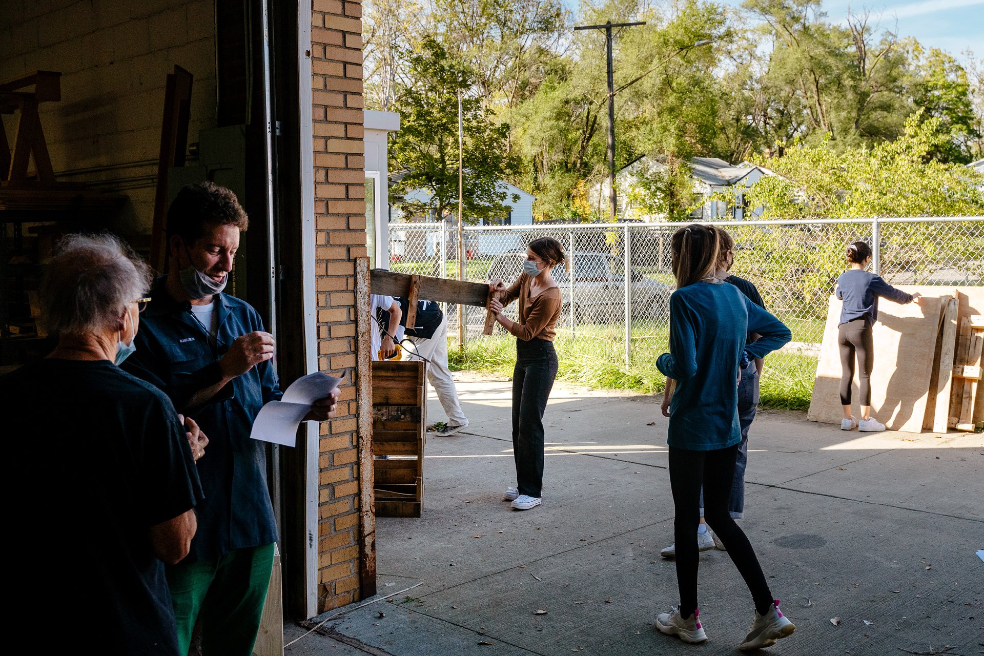 Nick Tobier, co-founder of the Brightmoor Maker Space, standing outside among several students, Kazam! Magazine.