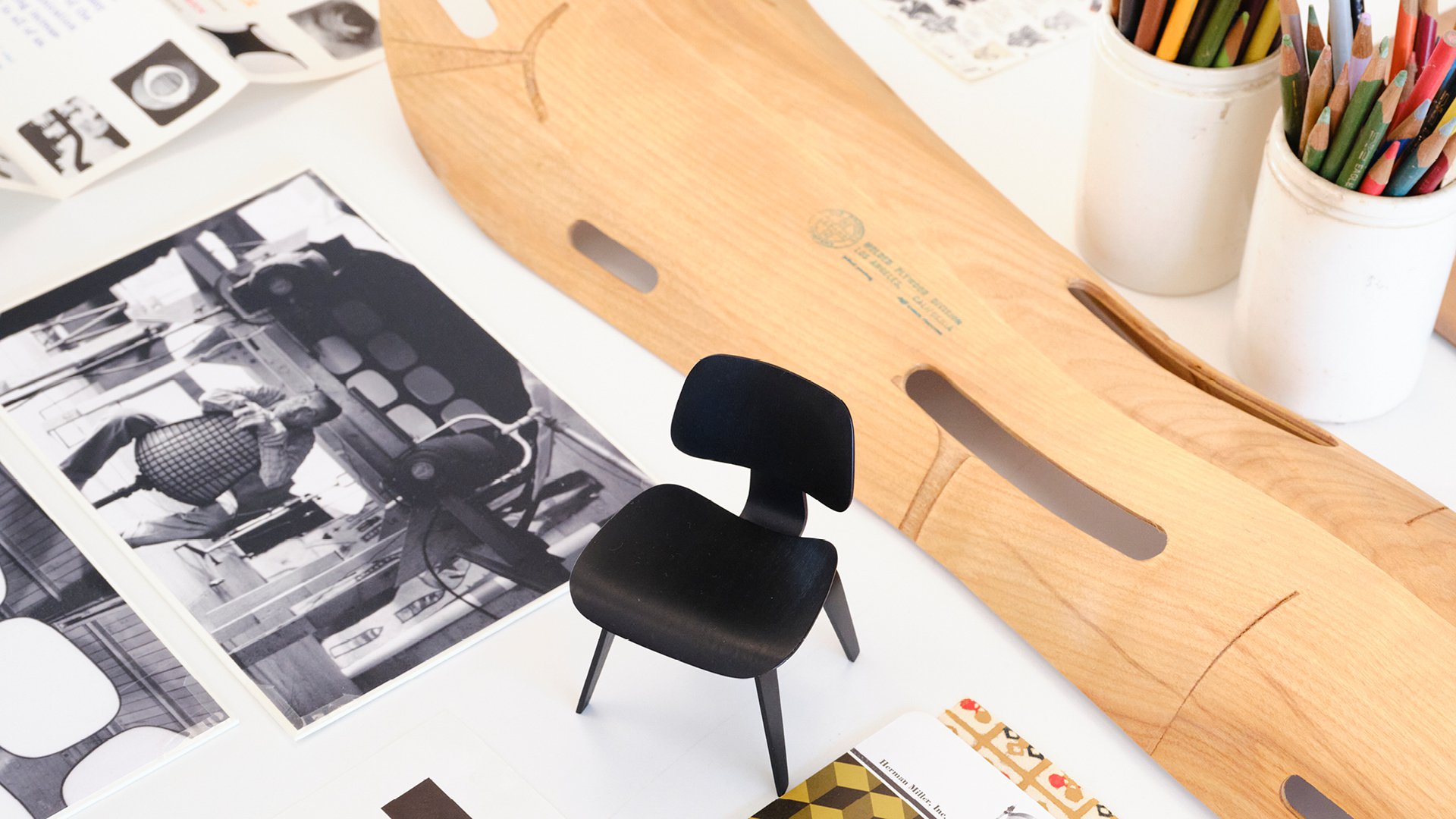 Collage image includes a black molded plywood Eames chair and leg splint, Kazam! Magazine.