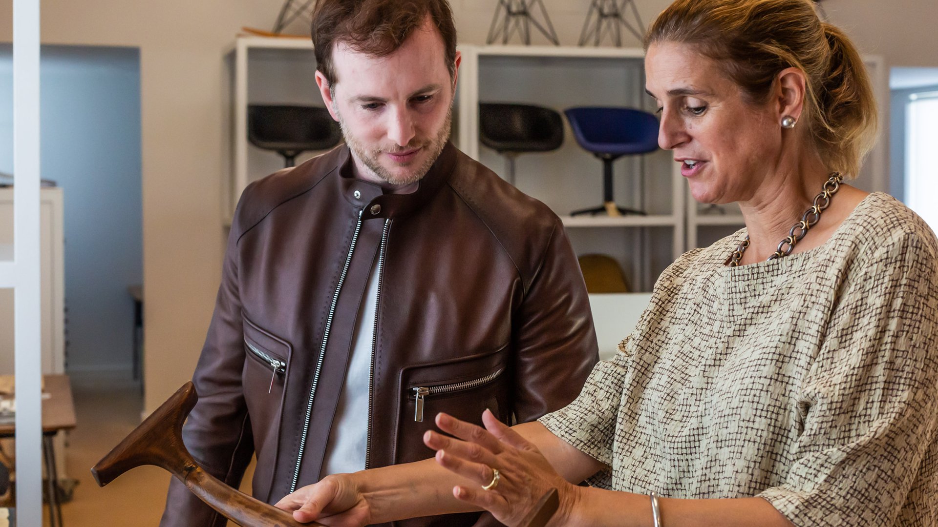 Airbnb cofounder Joe Gebbia and Eames Institute Chief Curator Llisa Demetrios, with a prototype part for an Eames chair.