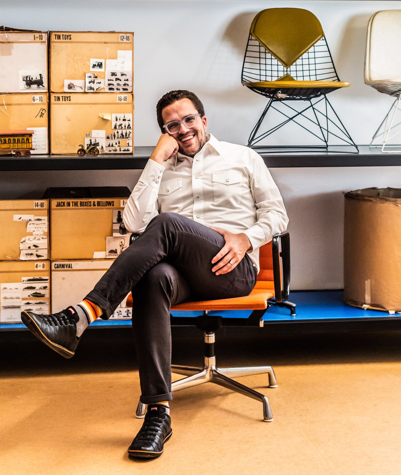 John Cary, president and CEO of the Eames Institute, sitting in an Eames chair at the Eames Ranch.