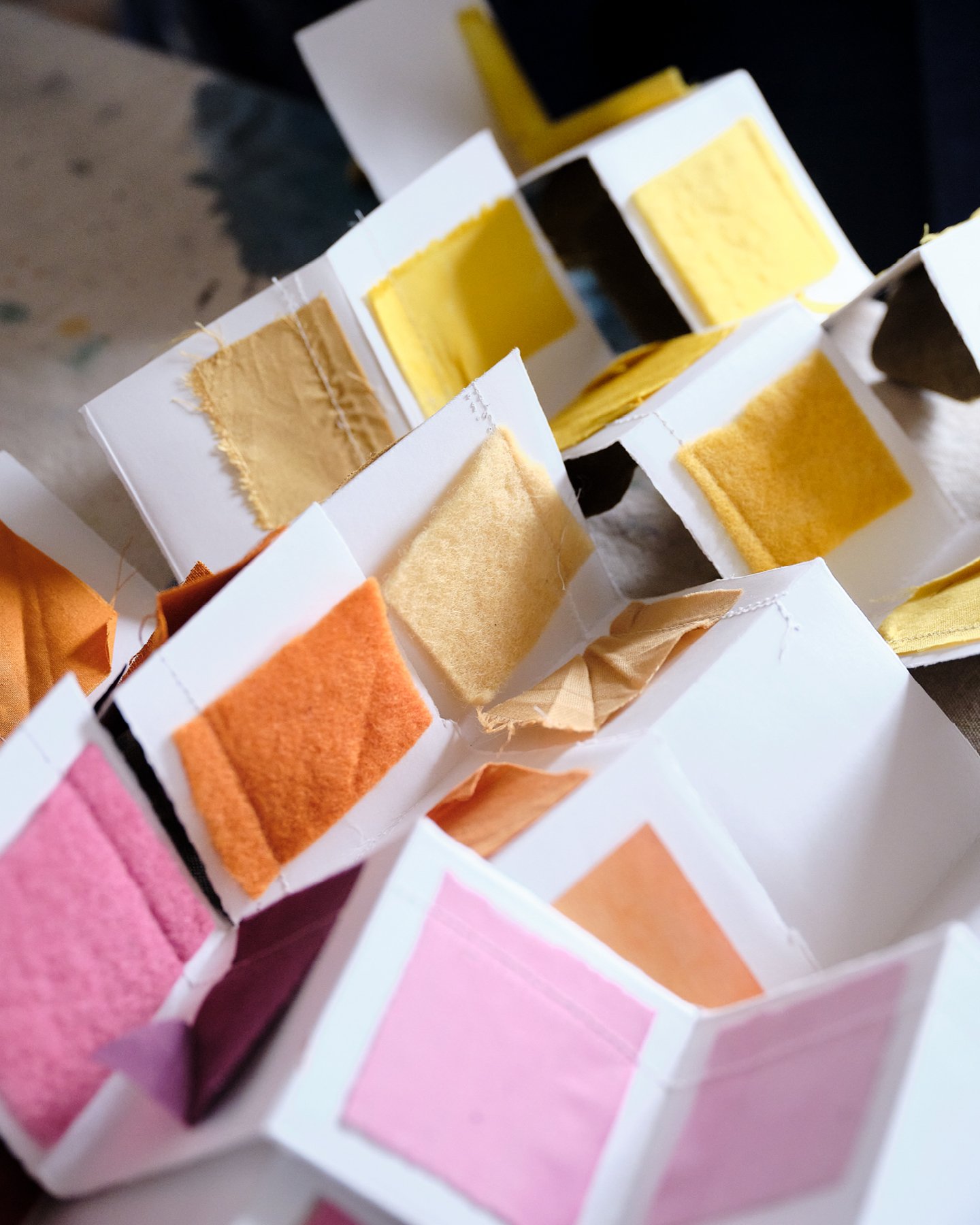 Textile swatches of many richly colored dyes made by abstract artist Natalie Stopka on display.