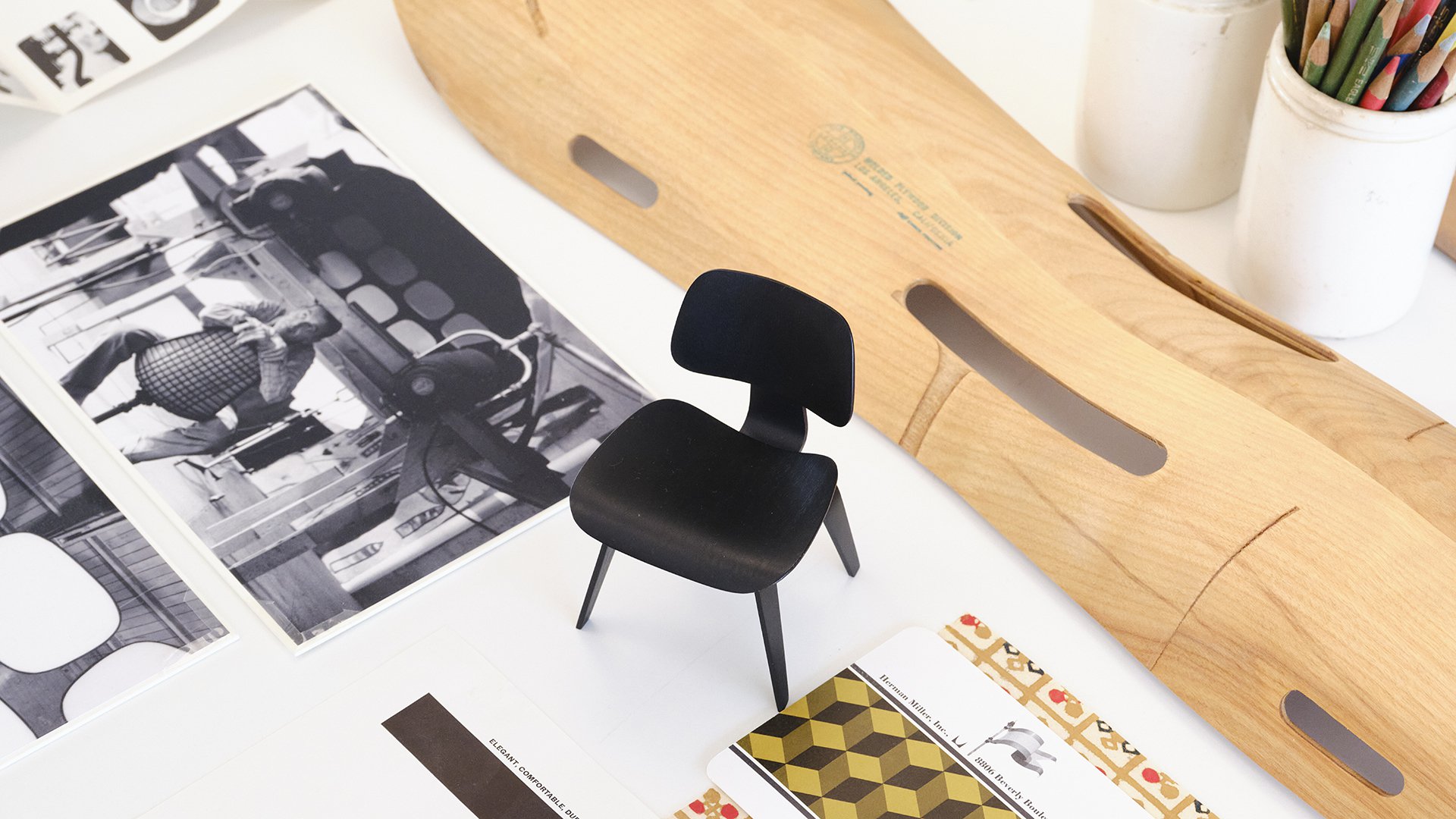 Collage image includes a black molded plywood Eames chair and a plywood leg splint.