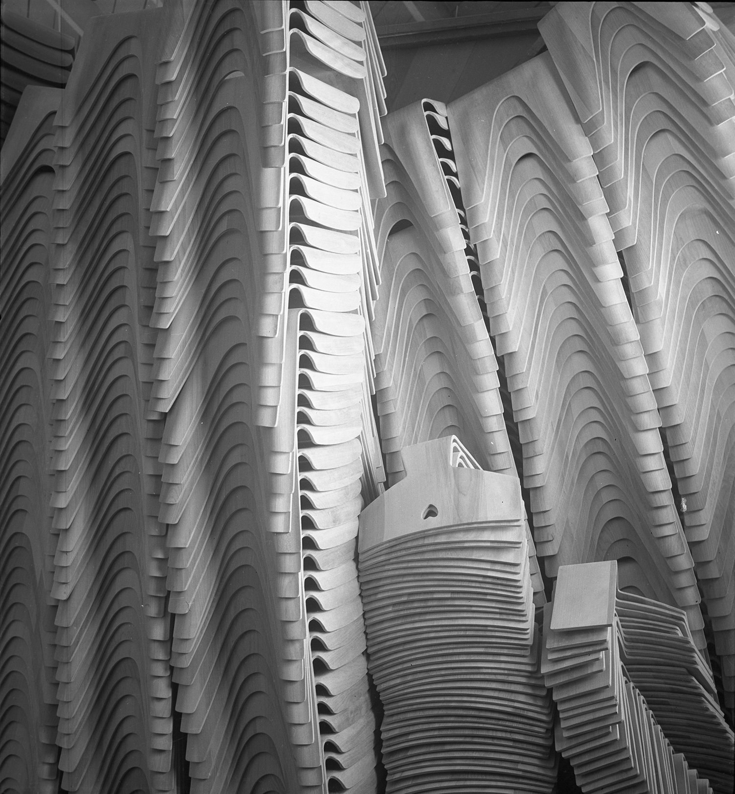 Close up view of stacks of Eames children's chairs and stools.