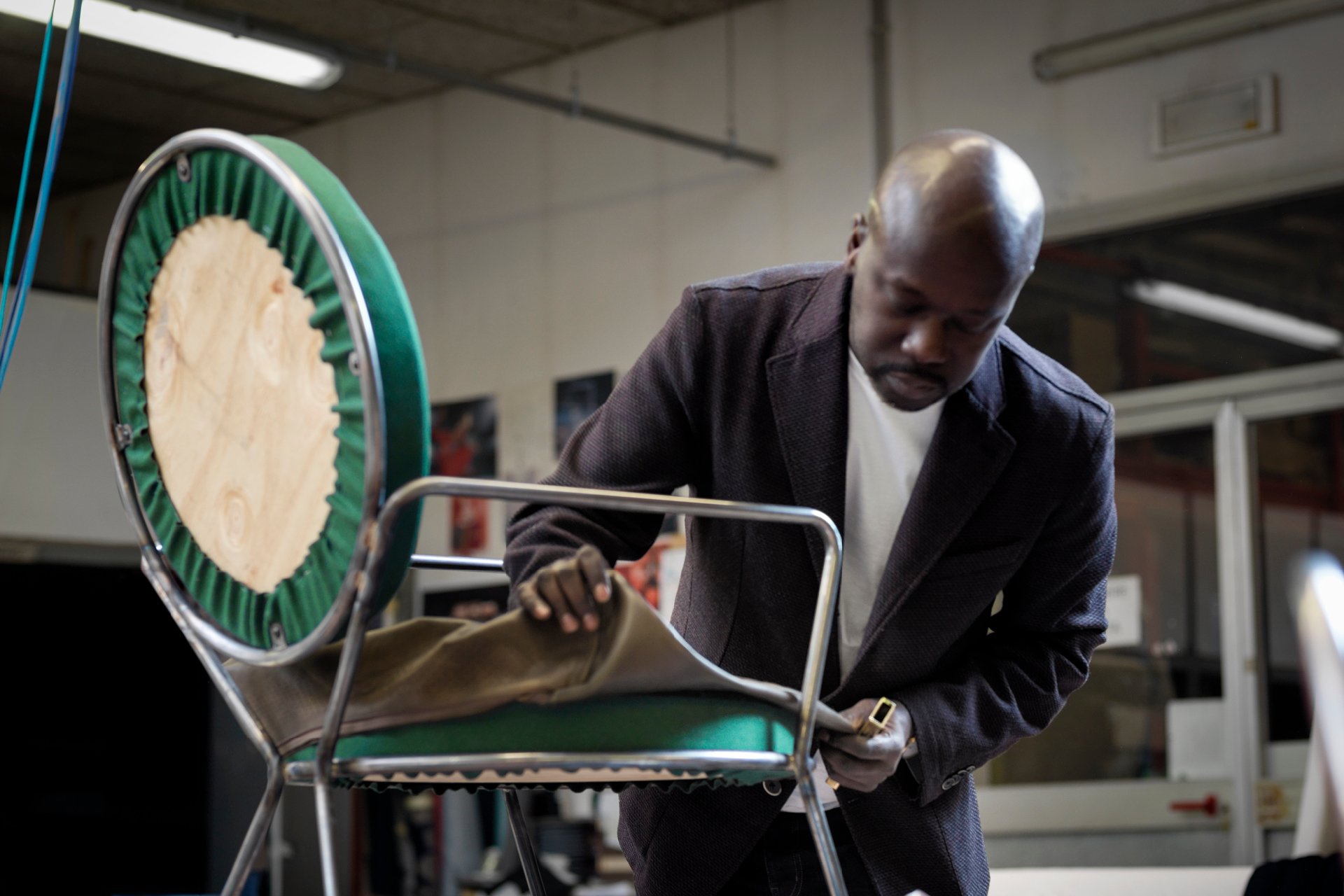Architect David Adjaye adjusts a prototype of his Double Zero chair, part of a series created for Moroso, at the company’s factory in Italy. © Alessandro Paderni