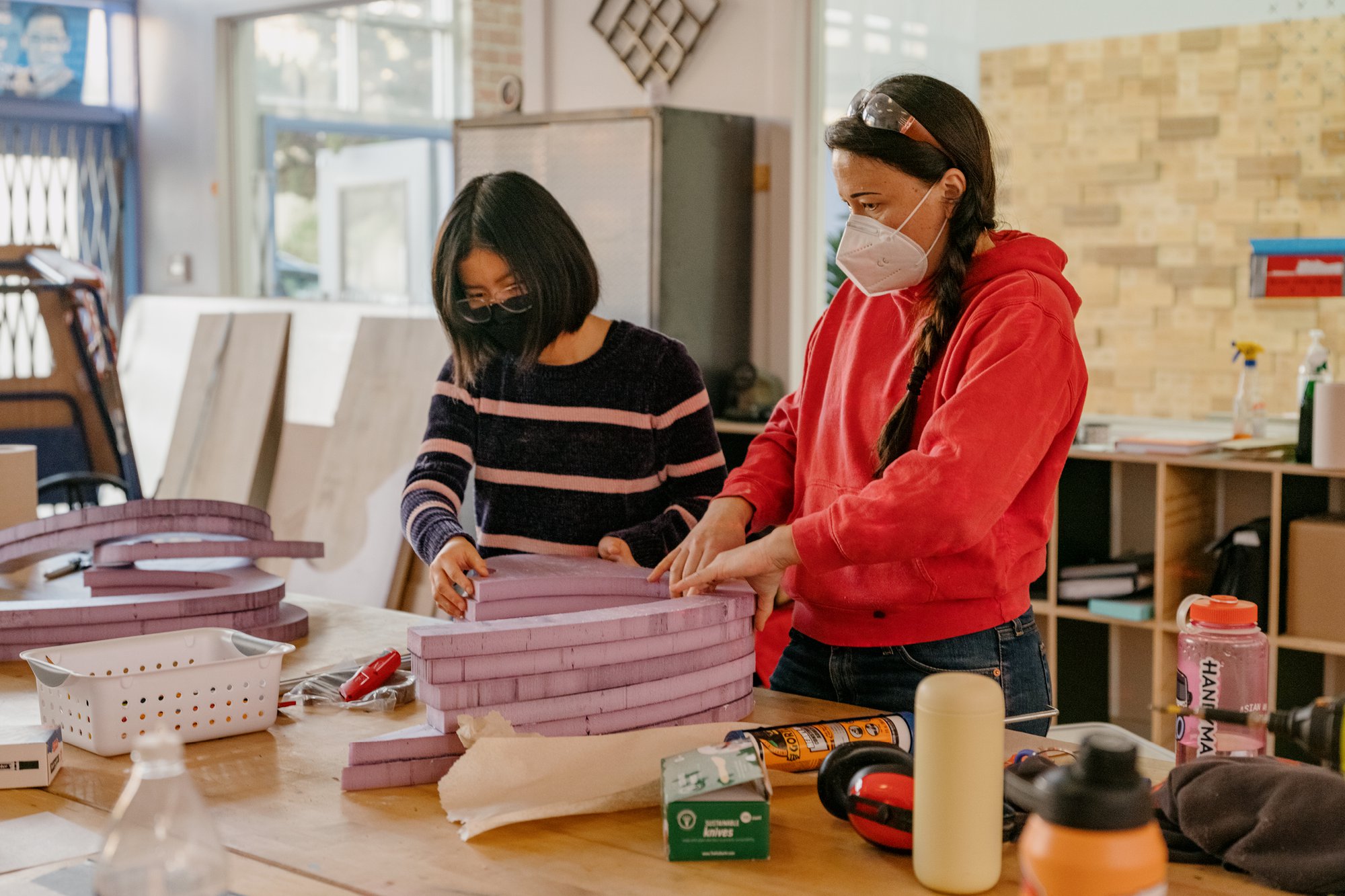Girls Garage, a workshop and design/build program in Berkeley California, showing Emily Pilloton-Lam and a student working on a project.