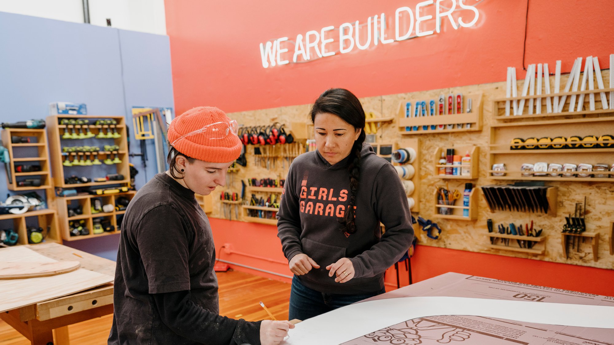 Emily Pilloton-Lam, founder and executive director of Girls Garage, a design/build workshop in Berkeley California. with a student at a work table.