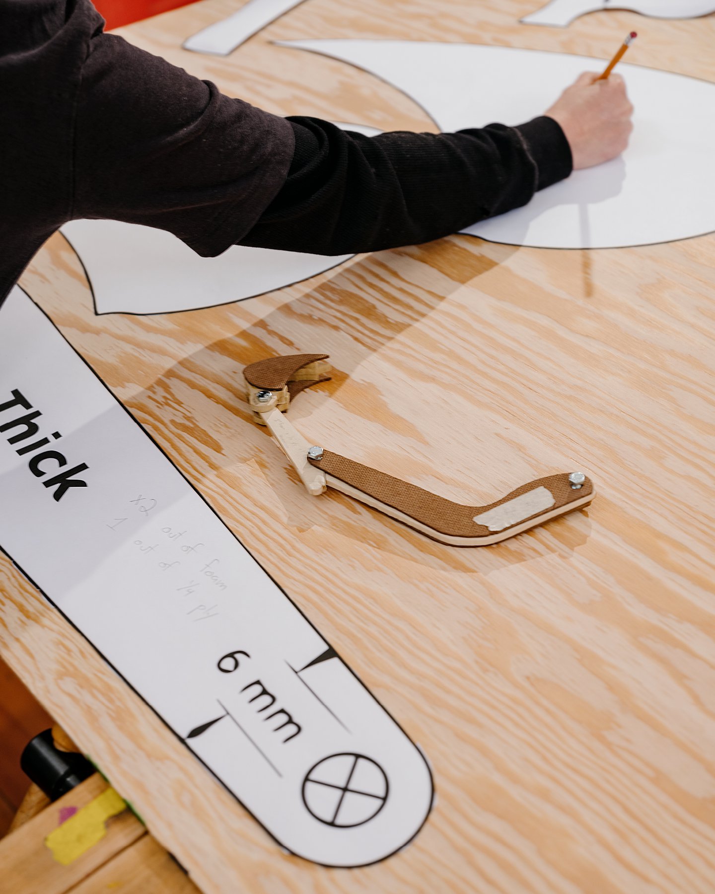 Girls Garage, a design/build workshop in Berkeley California, in the workshop showing a student tracing out a template.