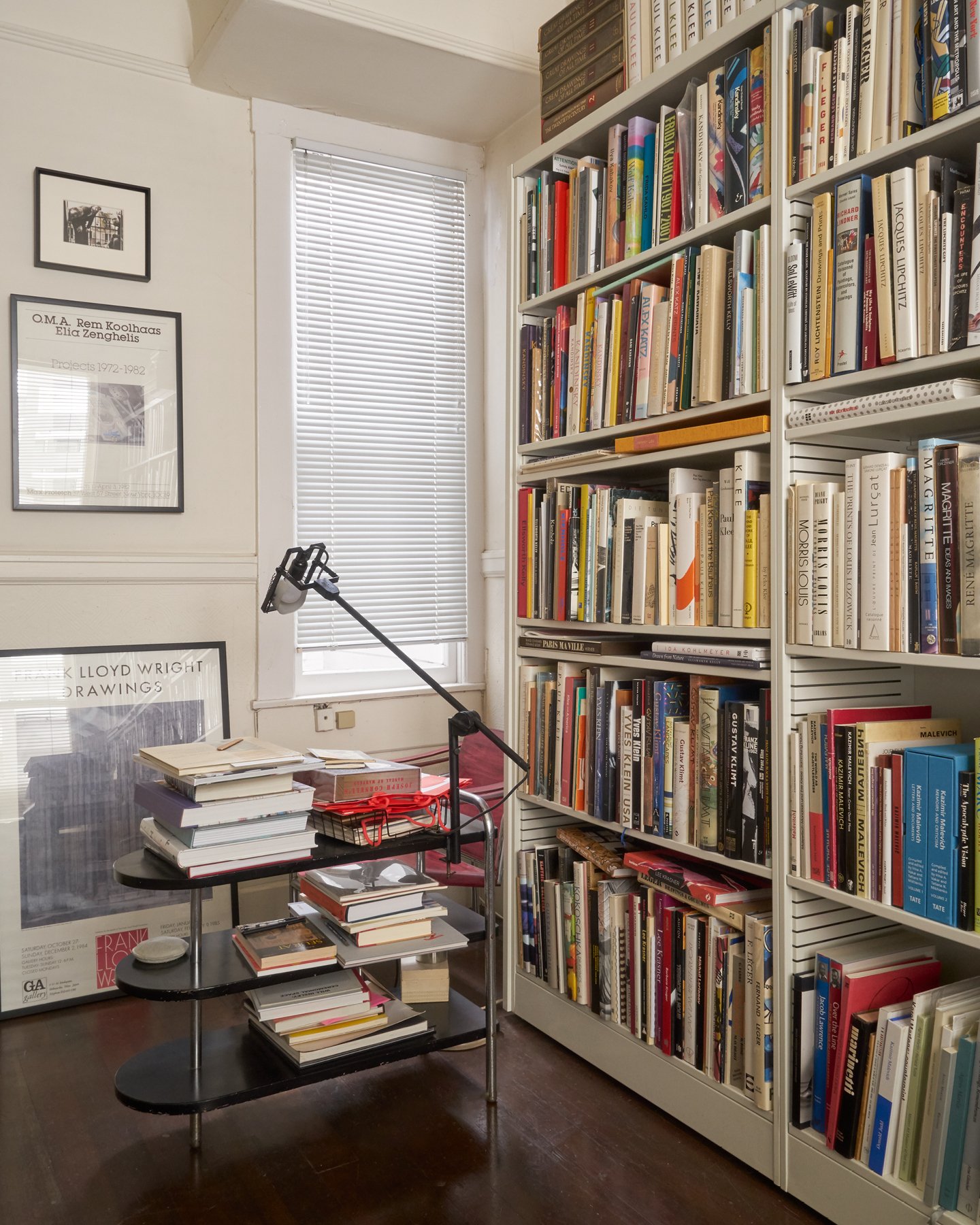 Vast amounts of art and architecture books lining many shelves in an interior space.