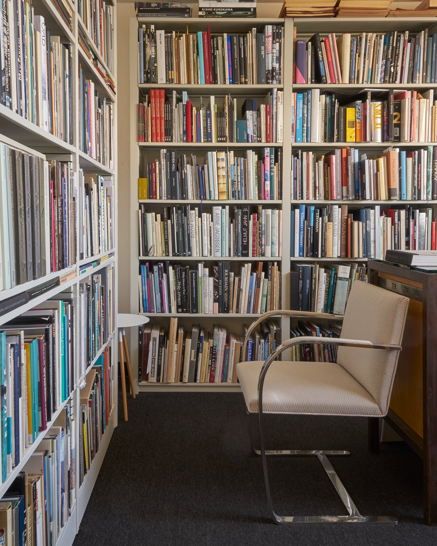 Tall bookshelves packed with art and architectural books.