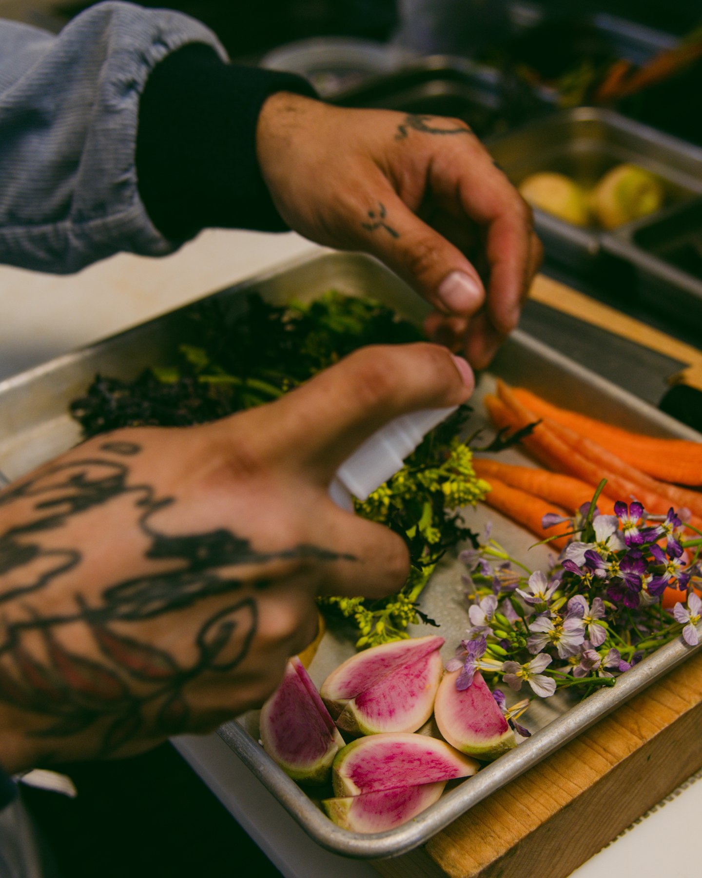 Chef and owner Andres Giraldo Florez preparing vegetables in the kitchen at Oakland California’s Snail Bar, Kazam! Magazine.